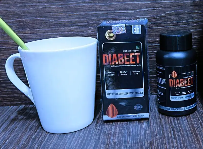 Diabeet capsule pack and bottle on a table beside a white mug